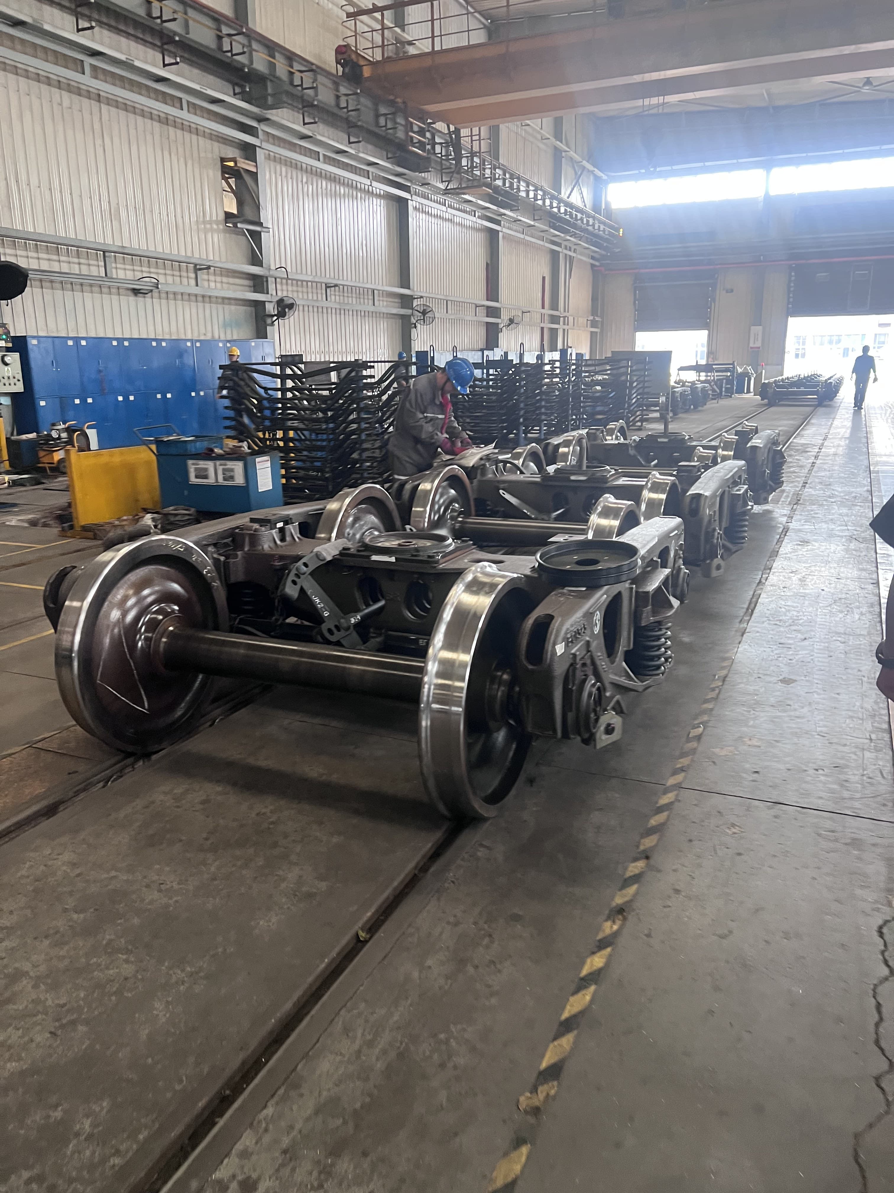 Railway bogies arranged along a manufacturing line