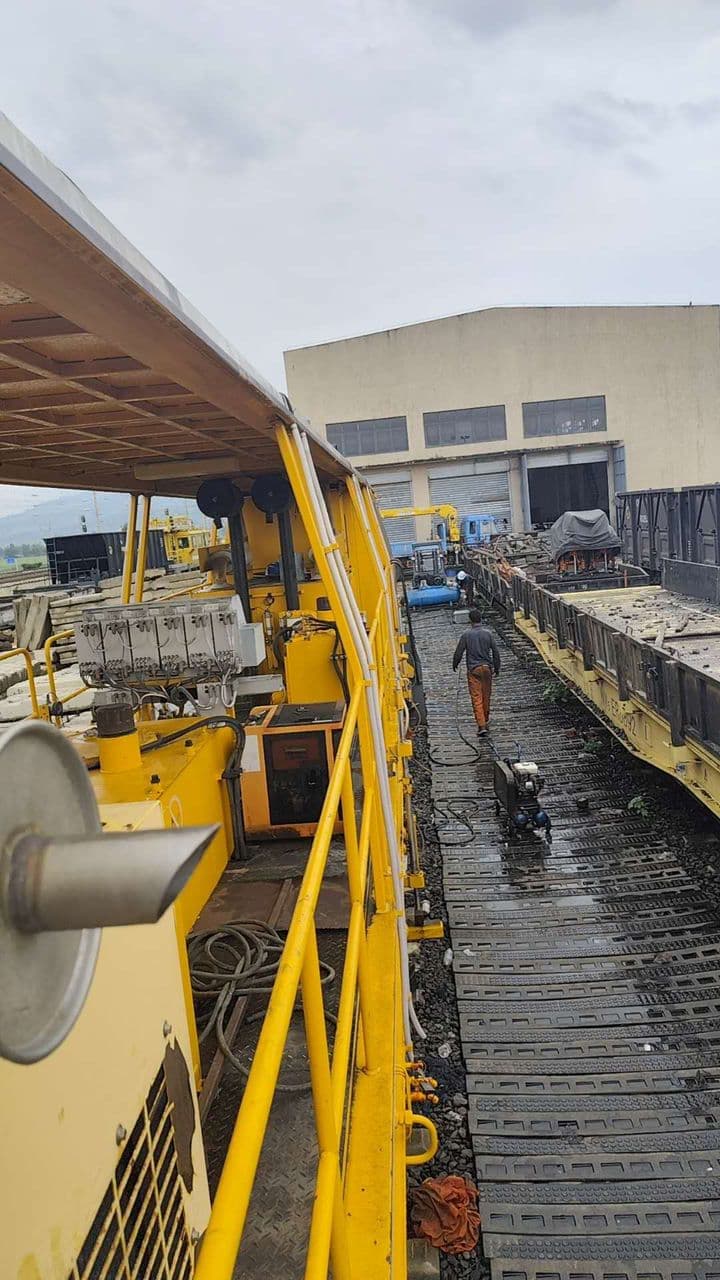 Railway maintenance machinery operating in a depot yard