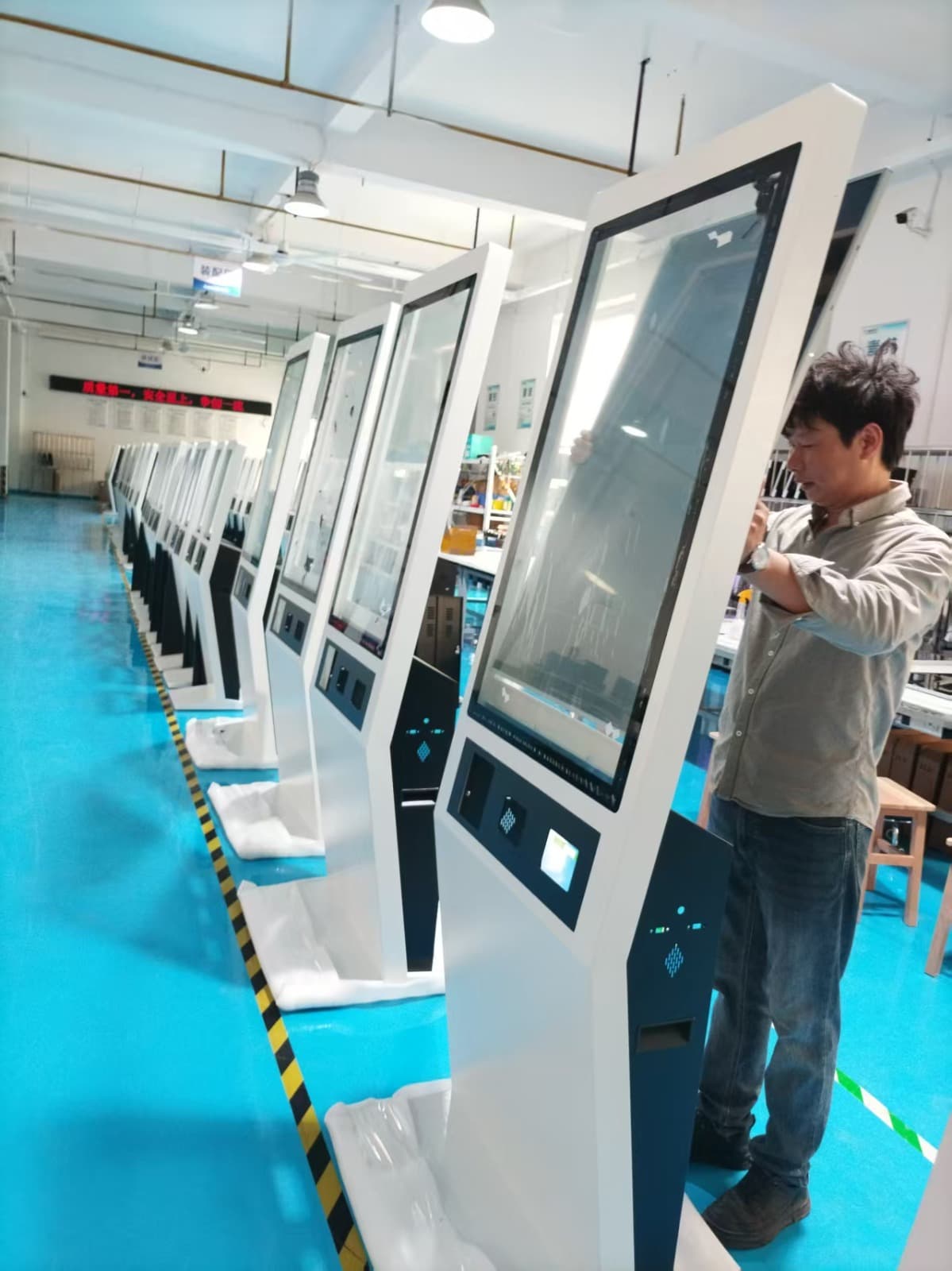 Digital kiosks being assembled on a manufacturing line